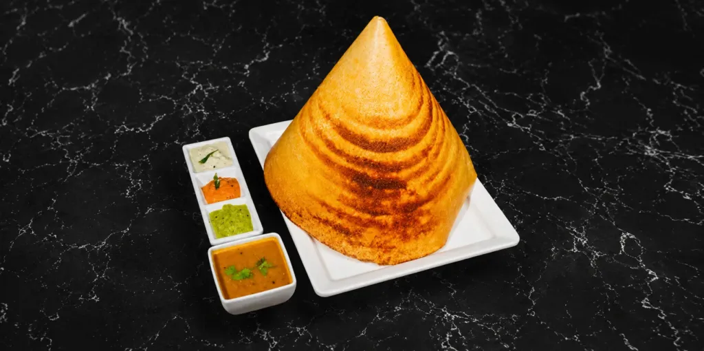 ALT Text Suggestion: Traditional South Indian family dinner with dosa at A2B NC 